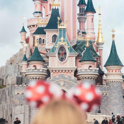 A whimsical castle with crowds at Disneyland Paris, capturing magical family moments.