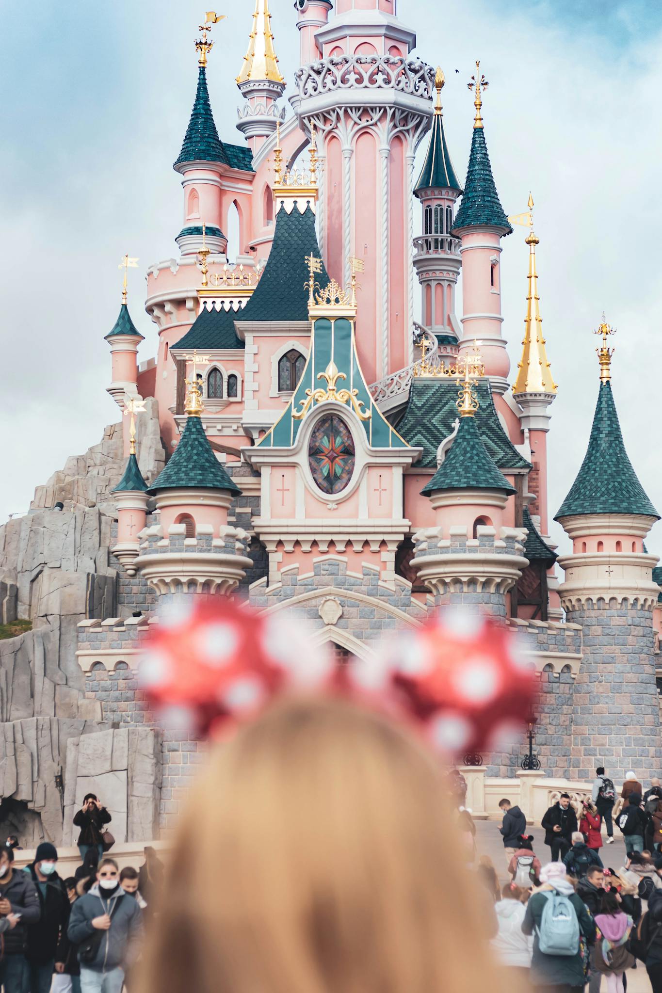 A whimsical castle with crowds at Disneyland Paris, capturing magical family moments.